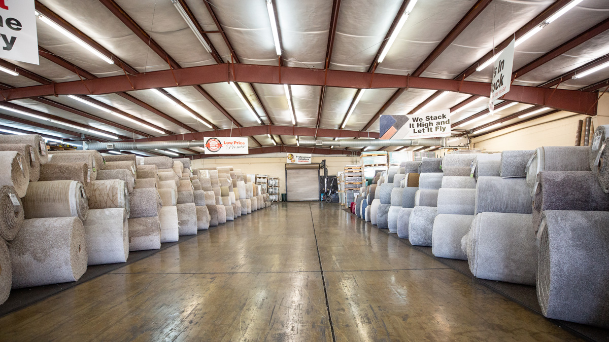 1200x675_homeSliderImgs_store_15 Flooring warehouse with many rolls of carpet.