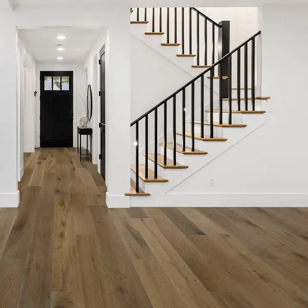 Bordeaux 1 Stairway scene - white room with steps going upstairs. Wood-look flooring.